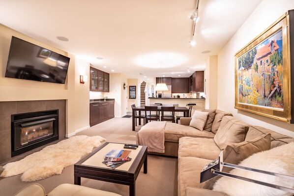 Gas fireplace and large screen TV in the living room area.