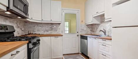 Galley-style kitchen. The door leads to the backyard.