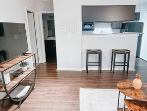 Living room view to bathroom and kitchen