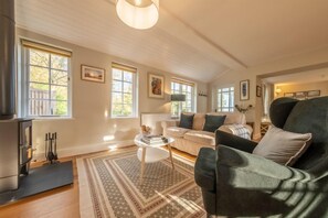 Bell Tower Cottage, Little Henny: Sitting area with wood burning stove and ample natural light