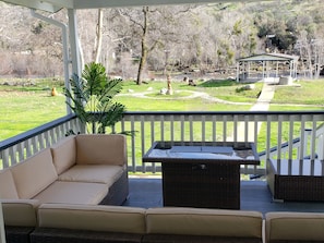 Patio deck with views of the River and park like backyard with amazing views.😍 