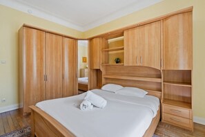 Cozy bedroom with built-in wardrobes and a warm, inviting ambiance.