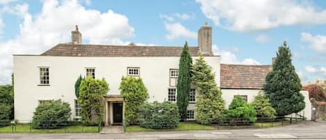 Front view of House. Car parks to the right and around the corner to the left