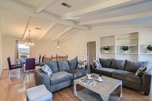 Sophisticated living room design with two sofas that open up to Quen size beds, 65” Smart TV, wood fireplace, beautiful decor, views of our ranch, and much more!