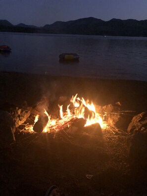 Our beach area with rock pit near water firewood supplied