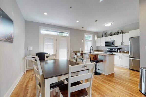 Middle Floor - Kitchen and Dining, with a patio off the back