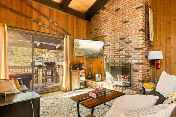 Living room featuring two decks off living room area, games, books, Amazon TV/Roku , HBO Max, YouTube and a air filter!