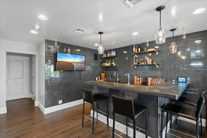 Bar with everything you need, including a networked TV.  Note iPad, controls AV.