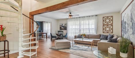 The living room includes a spiral stairway up to the kids' loft.