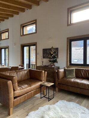 Relaxing open plan living room with large Smart TV, double doors to balcony