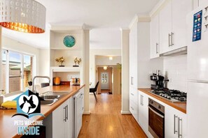 The kitchen is equipped with a breakfast bar and modern appliances