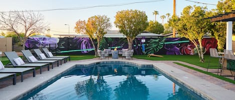 Private oasis complete with a glistening, optional heated pool, a blazing fire pit, a sizzling BBQ grill, a dining haven with an expansive yard for endless fun with corn hole, a putting green to perfect your golf game, and a brand-new mural to ignite your senses!