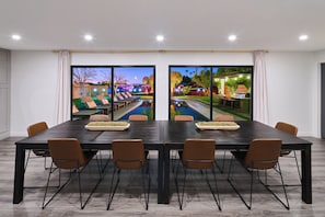 Elegant dining space offering breathtaking views of the enchanting backyard oasis.