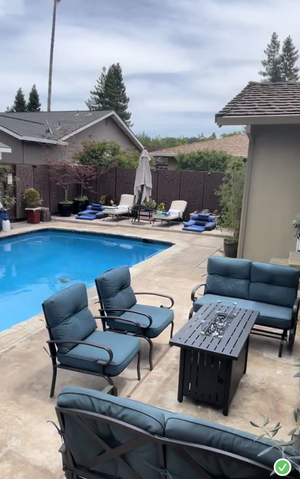 outdoor space, lounge seating around fire pit table, 2 chase lounge chairs