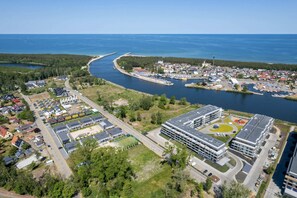 An aerial view showcasing a vibrant neighborhood surrounded by greenery and waterways.

