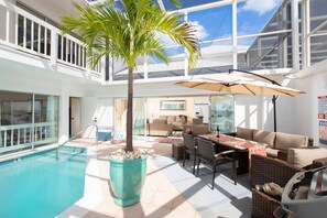 Splash into a private pool atrium with outdoor dining and shade!