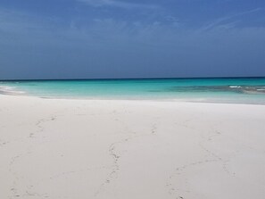 Just a short walk from a spectacular mile-long pink sand beach.