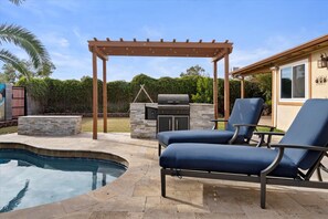 Outdoor kitchen and plenty of room to lounge by the pool 