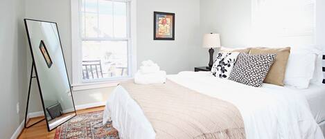 Front bedroom with queen bed, and comfy bedding.