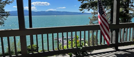 Emerald colored lake in the spring sunshine.  View from the deck.