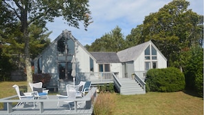 House back with dining and lounge areas overlooking meadow and Sengekontacket