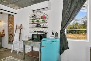Start your day off right with our convenient coffee bar, complete with a microwave and teal retro mini fridge. Perfect for storing snacks and drinks during your stay.
