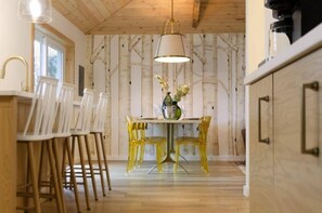 Nordic inspired dining room with an 8 foot long table that appears to be resting among the birch trees.  