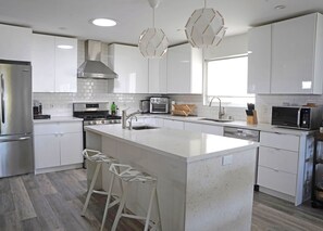 Full kitchen with modern appliances. French door fridge, kettle, toaster, etc.