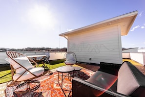 Private rooftop deck with lounge area, and outdoor dining.