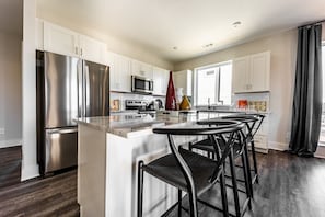 Fully equipped kitchen stocked with your basic cooking essentials. Complete with stainless steel appliances and breakfast bar seating.