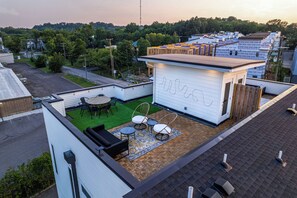 Private rooftop deck with lounge area, and outdoor dining.