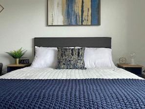 Queen size bed with luxury bedding.