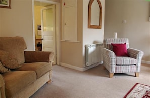 Comfortable lounge with cosy open fire at Cherry Tree Cottage in West Burton, Wensleydale in the Yorkshire Dales