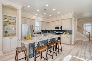 Spacious kitchen with barstool seating at the island.