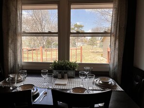 Kitchen table overlooking backyard. 