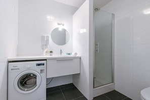 Bathroom with shower and washingmachine