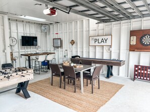 Game room with tv, scrabble, darts, JENGA, corn hole, shuffleboard, foosball