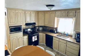 Fully stocked kitchen, dishwasher, dining table, 8 chairs, highchair