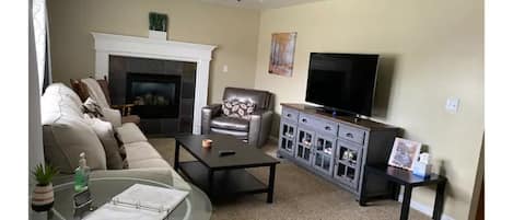 Comfy seating with gas fireplace and premium cable.