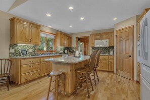 Beautiful kitchen with center island and walk in pantry.