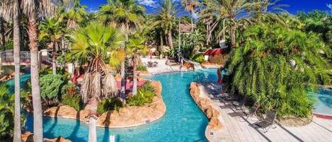 Lush Tropical resort with pool, lazy river and water slide.