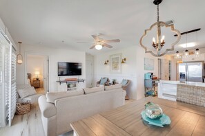 The perfect gathering spot - a comfy couch and pillowed chairs set around a HDTV