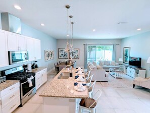 Bright kitchen with stainless steel appliances, granite countertops, and all the essentials for cooking and entertaining!
