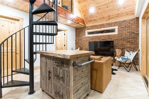 spiral stairway leading to the loft bedroom in the ground level house