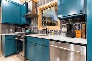 Gas stove microwave and Keurig in the full kitchen in the ground level house