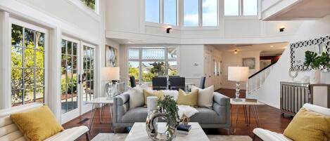 Light filled living room with gas fireplace.