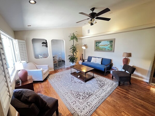 Livingroom with comfortable seating, sleeper sofa, desk, TV and plenty of space