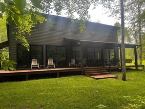 Back house/yard - Charcoal grill, deck, grassy lawn, hammock, fire pit, lounge chairs, outdoor dining table & chairs, patio, picnic table.