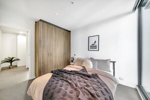 The master bedroom with a queen sized & city views.