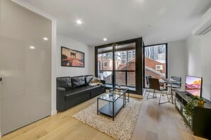 The living area with a 3-seater sofa bed.